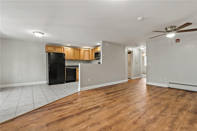 kitchen with ceiling fan, light hardwood / wood-style flooring, a baseboard heating unit, light brown cabinetry, and black appliances