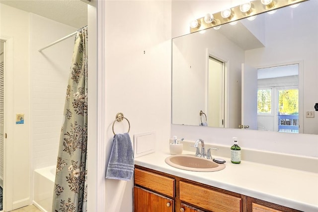 bathroom with shower / bath combination with curtain and vanity