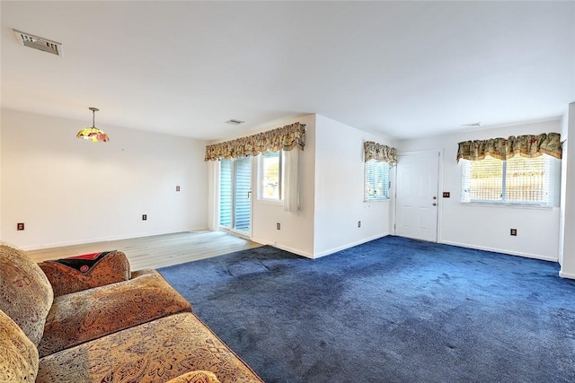 living room with dark colored carpet