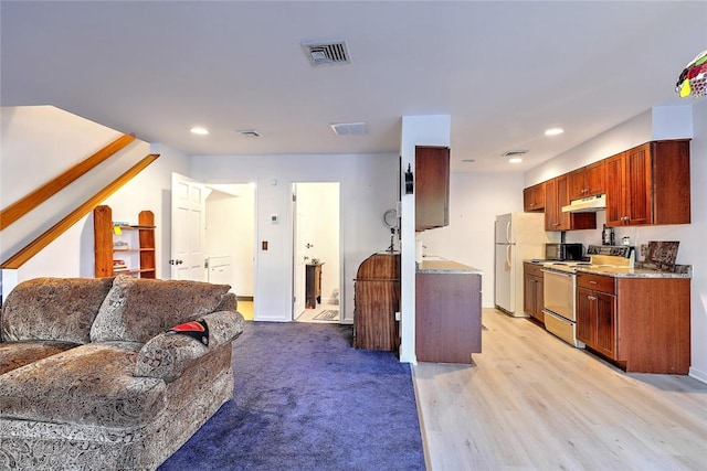 kitchen featuring light hardwood / wood-style floors and white appliances