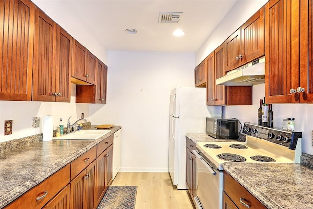 kitchen featuring white dishwasher, sink, light wood-type flooring, light stone counters, and range with electric stovetop