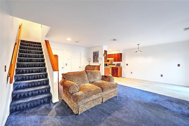 living room with dark colored carpet