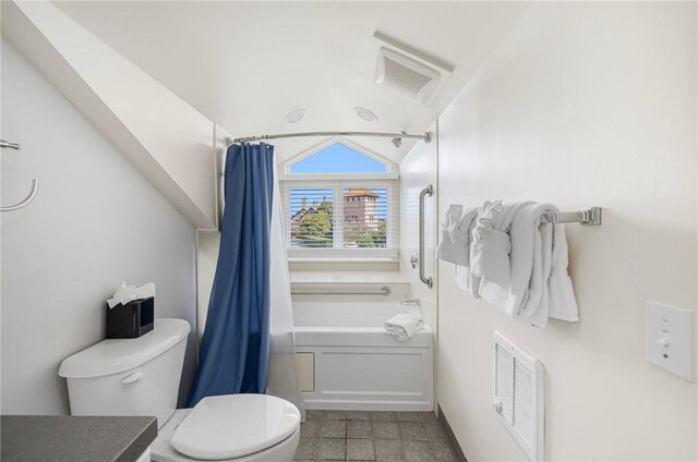 bathroom with tile patterned floors, shower / bath combination with curtain, toilet, and vaulted ceiling