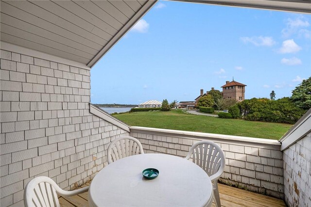 balcony with a deck with water view