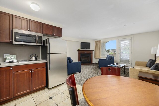 kitchen featuring appliances with stainless steel finishes and light tile patterned floors