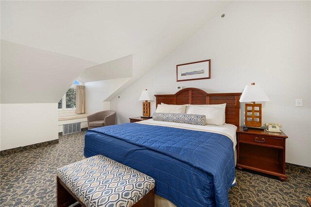 carpeted bedroom with vaulted ceiling