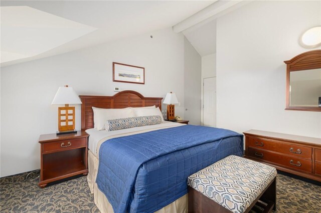 bedroom with vaulted ceiling with beams