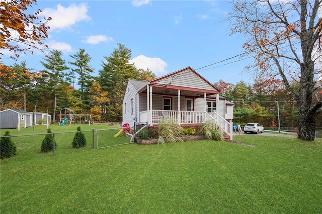 bungalow-style house featuring a playground, covered porch, and a front yard