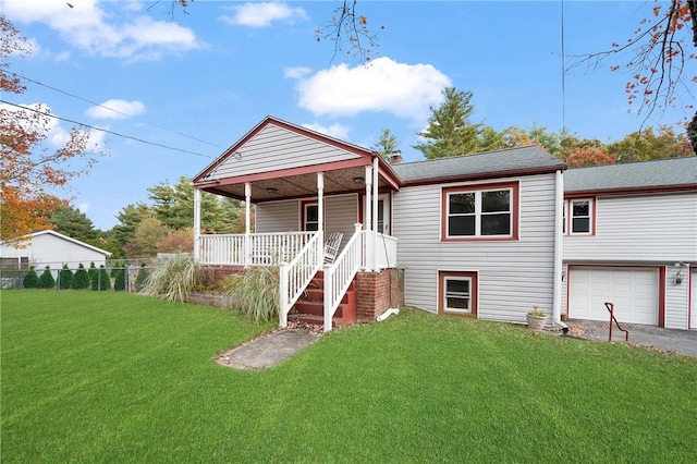 view of front facade with covered porch, a garage, and a front lawn