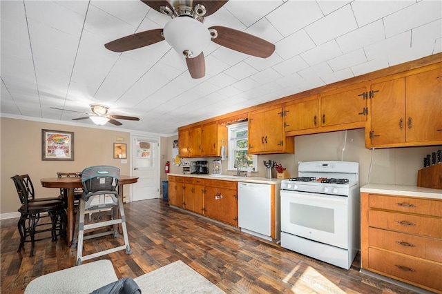 kitchen with dark hardwood / wood-style flooring, white appliances, ceiling fan, and ornamental molding