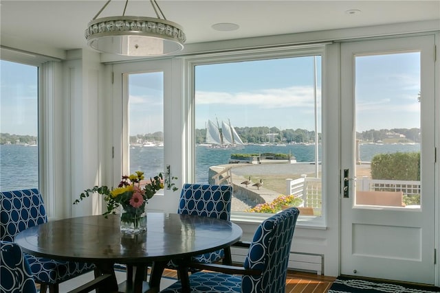 sunroom / solarium featuring a water view