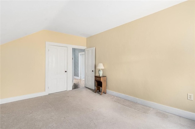 bonus room featuring light carpet and vaulted ceiling