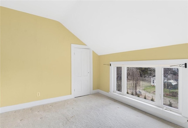 bonus room with carpet flooring and vaulted ceiling