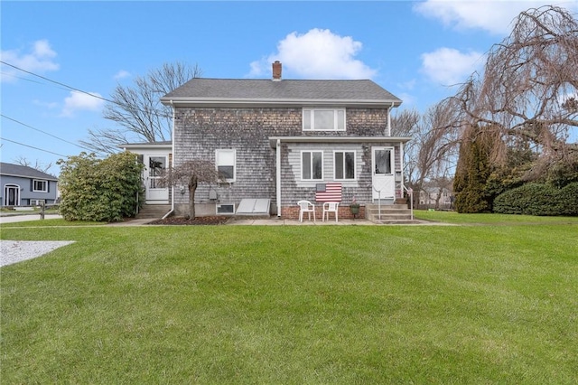 rear view of property with a lawn