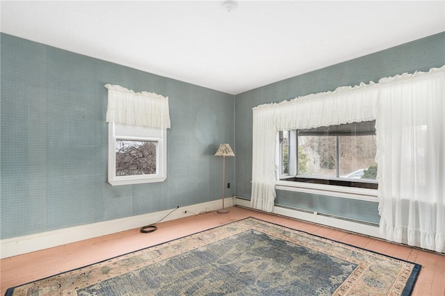 empty room with a baseboard radiator and wood-type flooring