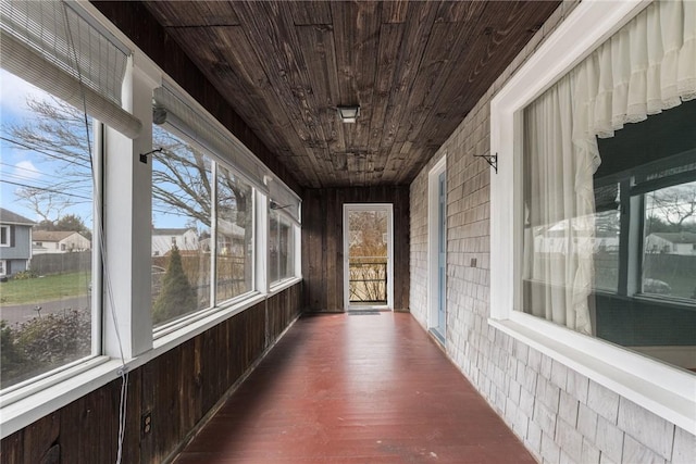 unfurnished sunroom featuring wooden ceiling