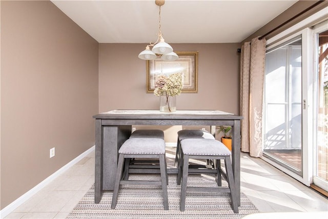 dining room featuring a chandelier, light tile patterned floors, and a wealth of natural light