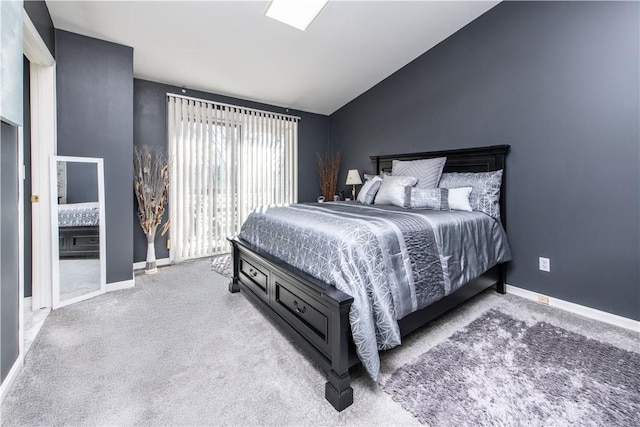 carpeted bedroom featuring lofted ceiling