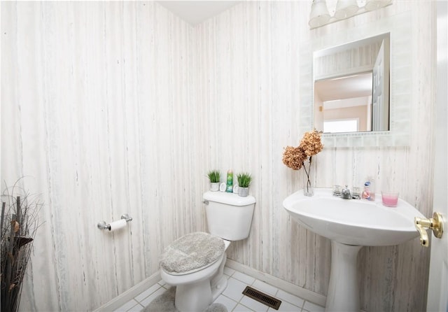 bathroom featuring tile patterned flooring and toilet