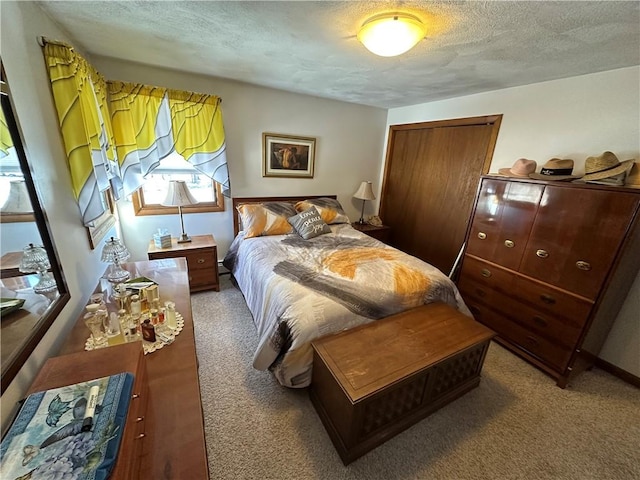 carpeted bedroom featuring a textured ceiling and a closet