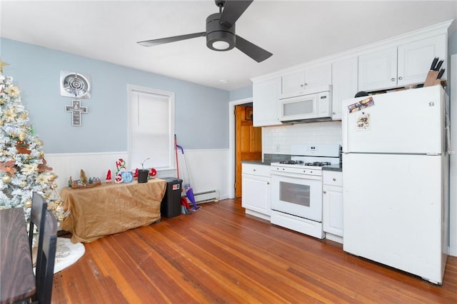 kitchen with white cabinets, dark wood-type flooring, and white appliances