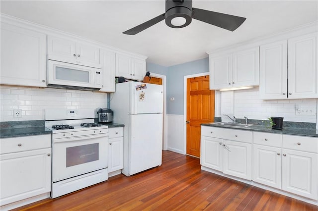 kitchen with white cabinetry, sink, ceiling fan, dark hardwood / wood-style floors, and white appliances