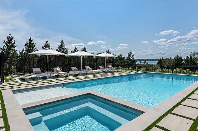 view of swimming pool featuring a patio area and an in ground hot tub