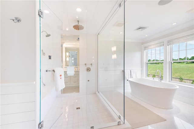 bathroom featuring crown molding, tile patterned flooring, tile walls, and shower with separate bathtub