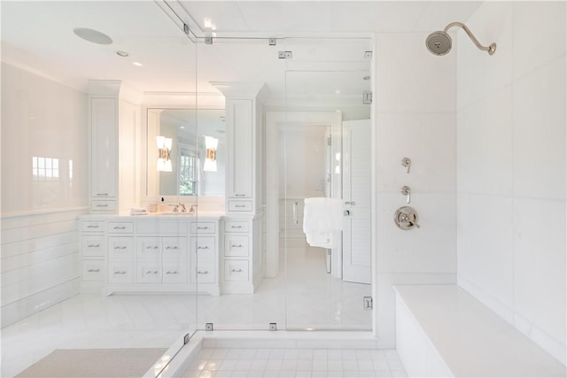 bathroom with tile patterned floors, vanity, ornamental molding, and walk in shower