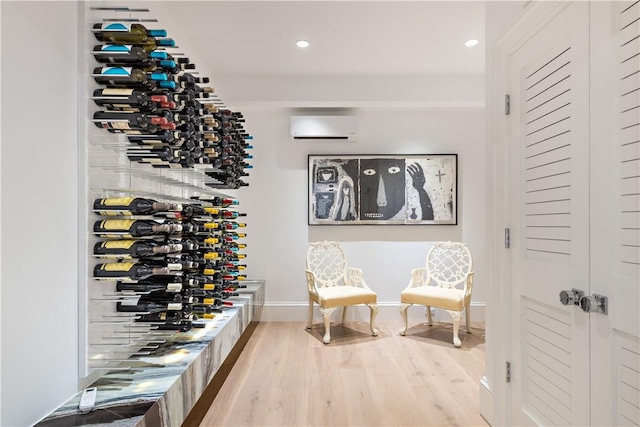 wine area with a wall mounted AC and hardwood / wood-style floors