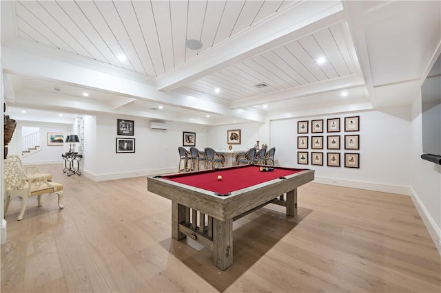 recreation room with beamed ceiling, light hardwood / wood-style floors, a wall unit AC, and pool table