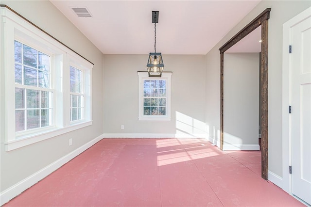 unfurnished dining area featuring plenty of natural light