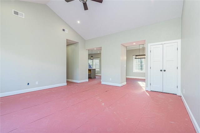 unfurnished bedroom with ceiling fan and high vaulted ceiling