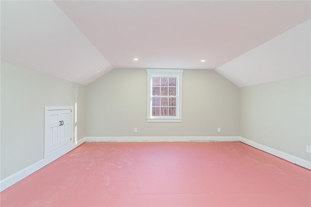 additional living space featuring lofted ceiling