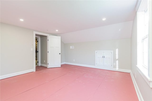 spare room with vaulted ceiling