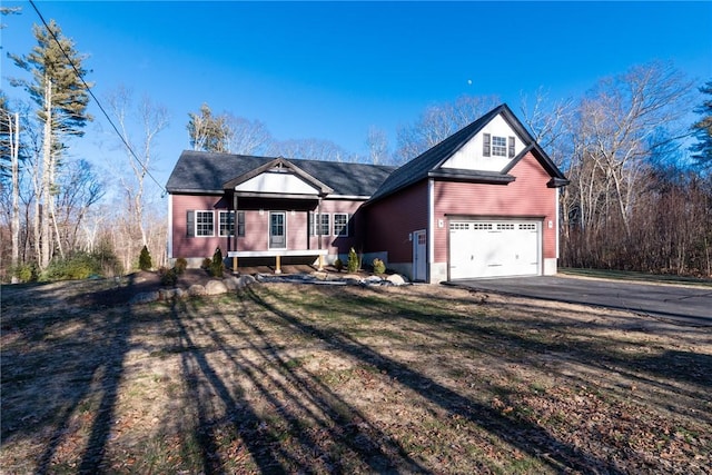 view of front of house featuring a garage and a front lawn