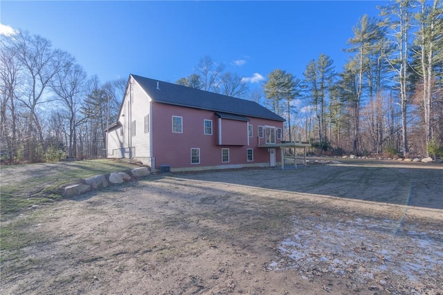 rear view of property featuring a wooden deck