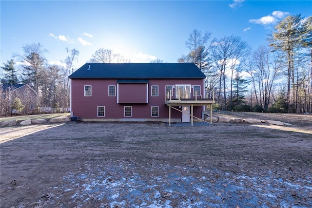 back of house with a deck and central AC