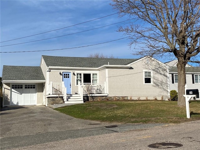 view of front of property with a front yard and a garage