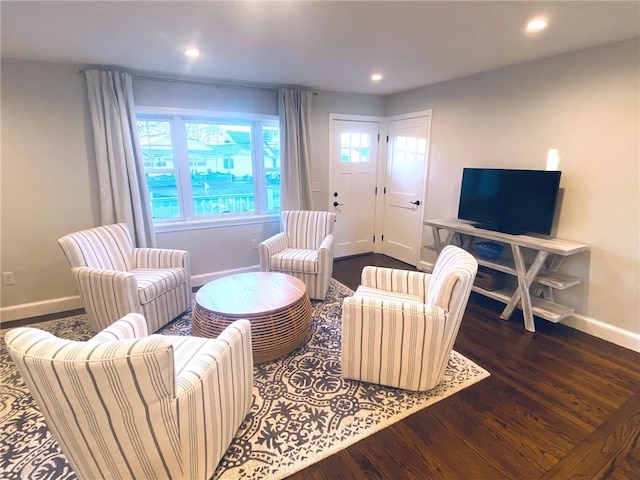 living room with dark hardwood / wood-style flooring