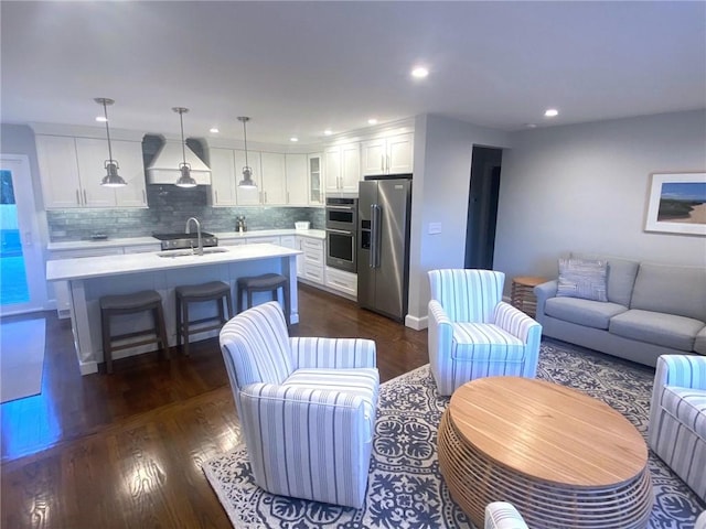 living room with sink and dark wood-type flooring