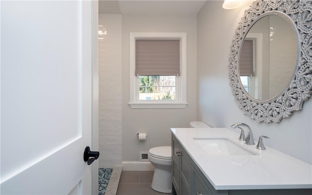 bathroom with tile patterned floors, vanity, and toilet