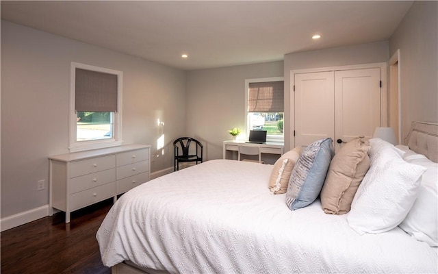 bedroom with a closet and dark wood-type flooring