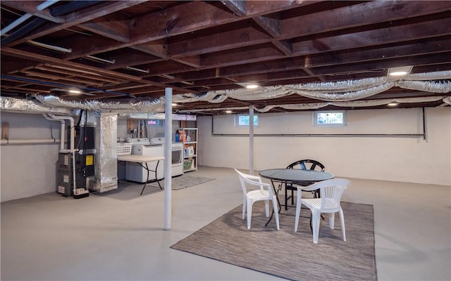 basement with heating unit and washing machine and clothes dryer