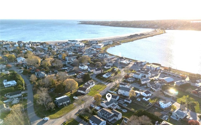 drone / aerial view with a water view and a beach view