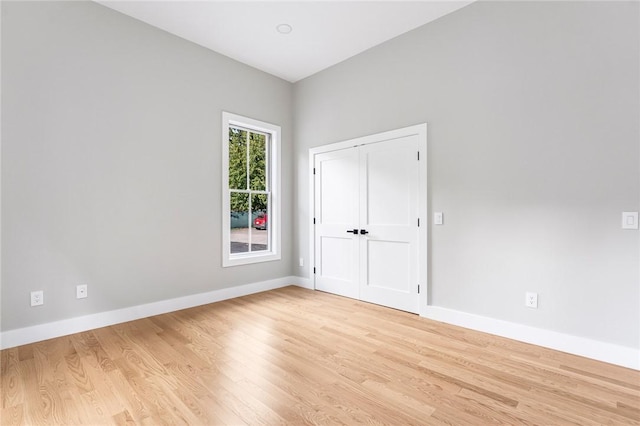 spare room with light hardwood / wood-style flooring