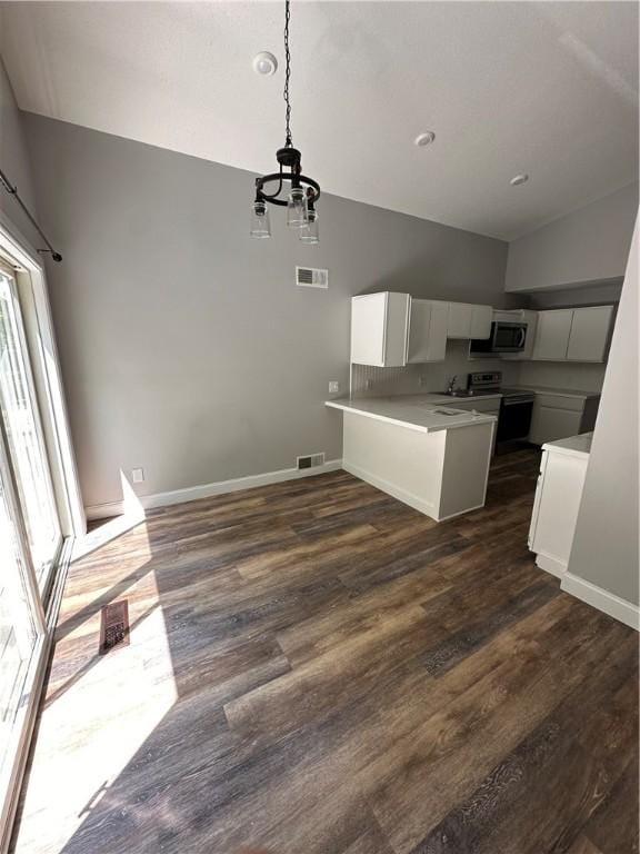 kitchen featuring kitchen peninsula, dark wood-type flooring, hanging light fixtures, white cabinetry, and black / electric stove