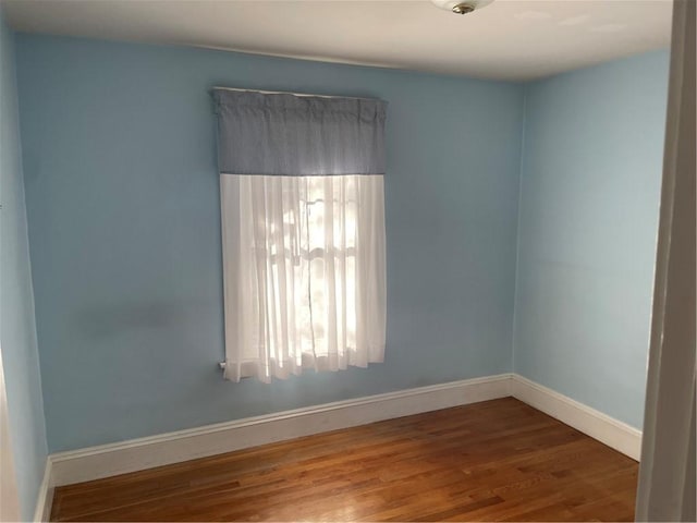 unfurnished room featuring hardwood / wood-style flooring