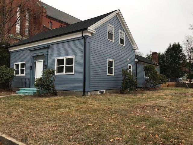 view of property exterior with a lawn