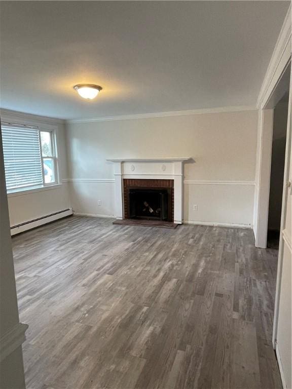 unfurnished living room with hardwood / wood-style flooring, ornamental molding, a baseboard radiator, and a brick fireplace